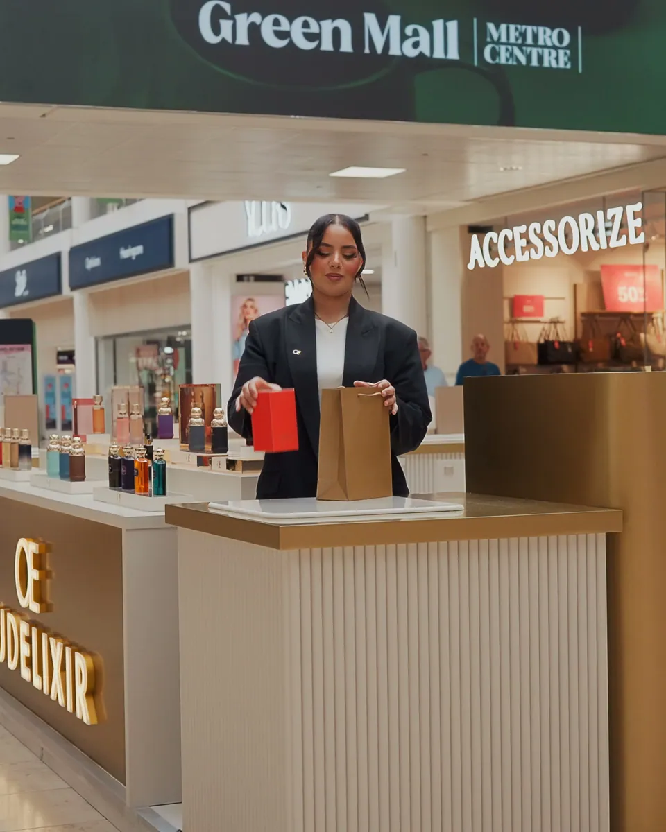 Retail team member at the DXB Perfume counter, from a DS Media brand film