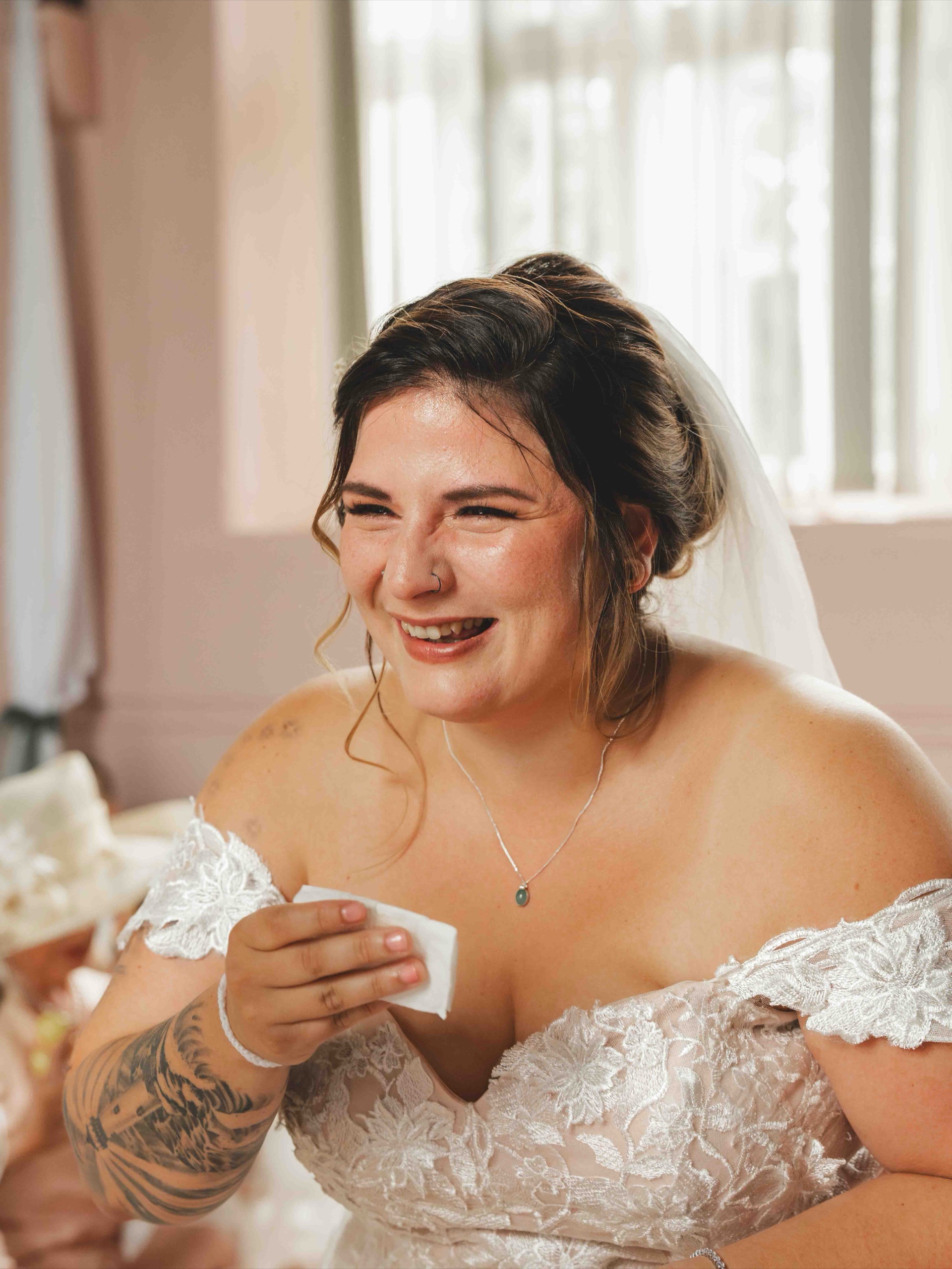 Cessca laughing with emotion during the wedding ceremony