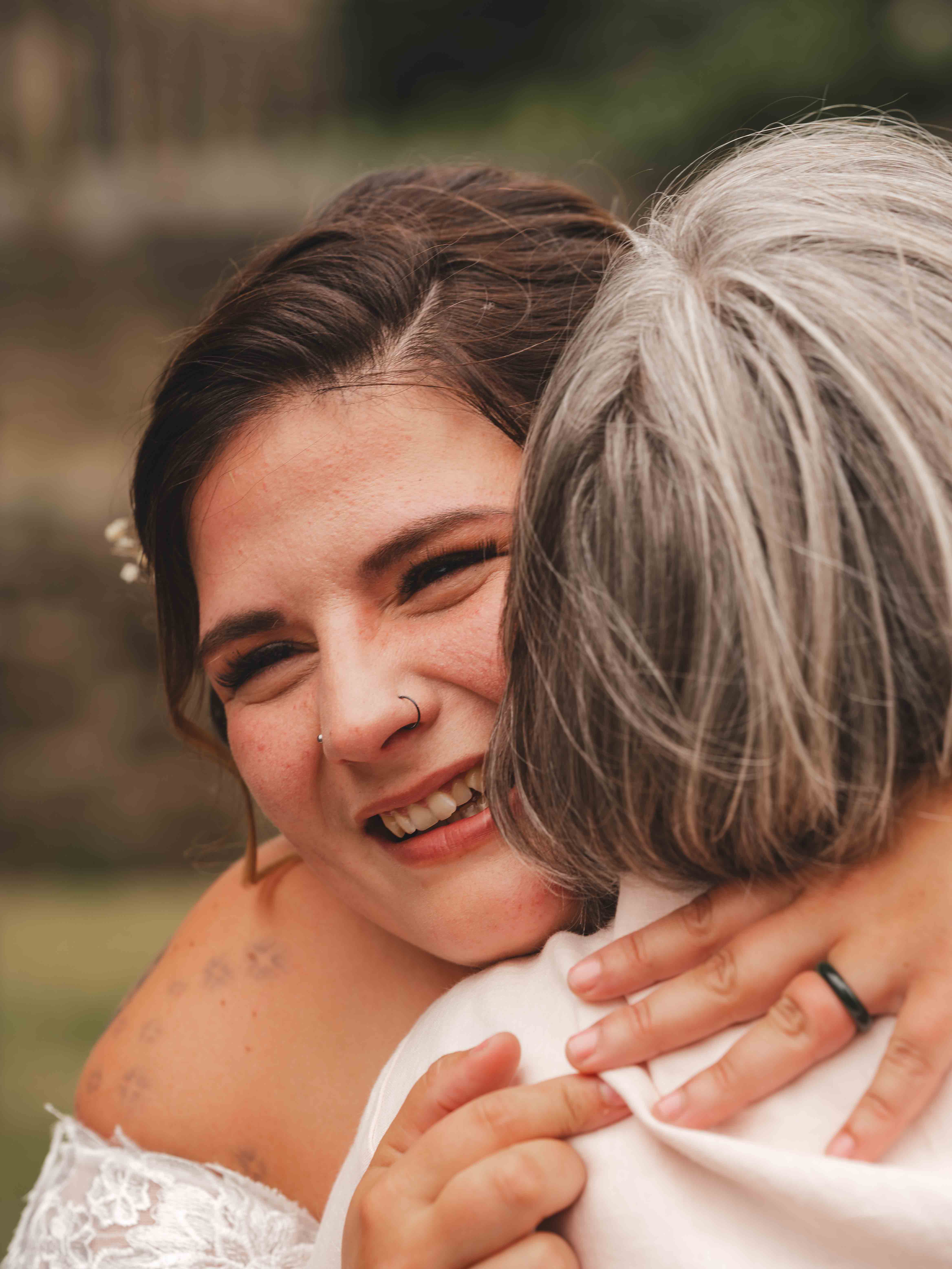 Cessca sharing a heartfelt embrace with a loved one outside the venue after the ceremony