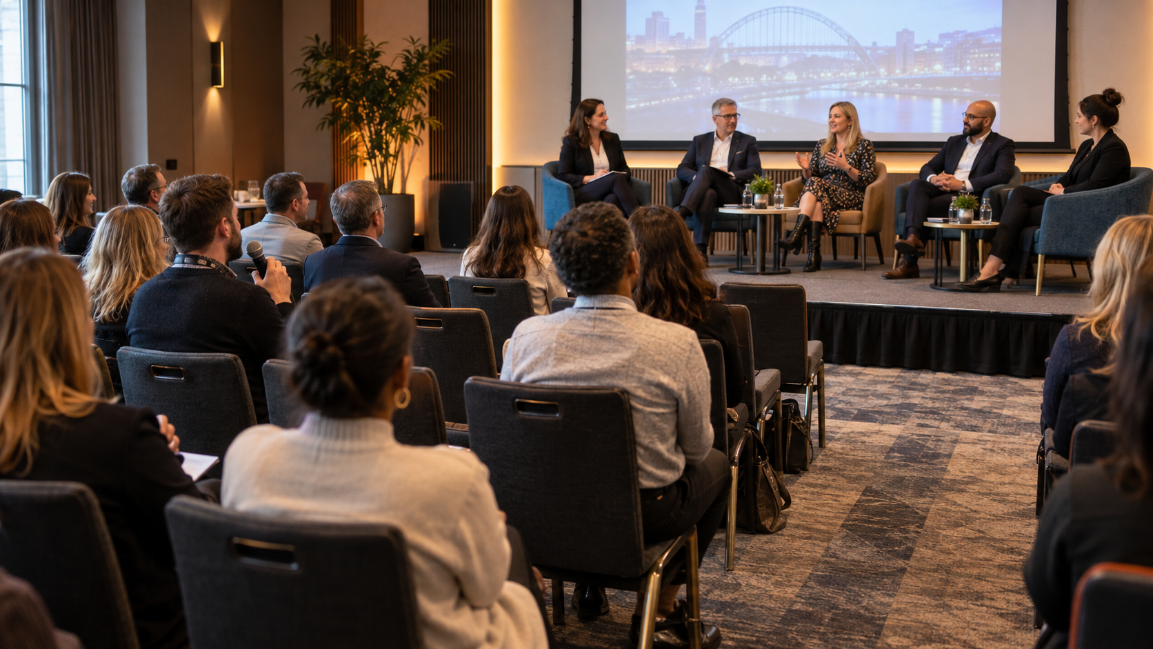 Panel discussion in a compact conference room with clear audience sightlines