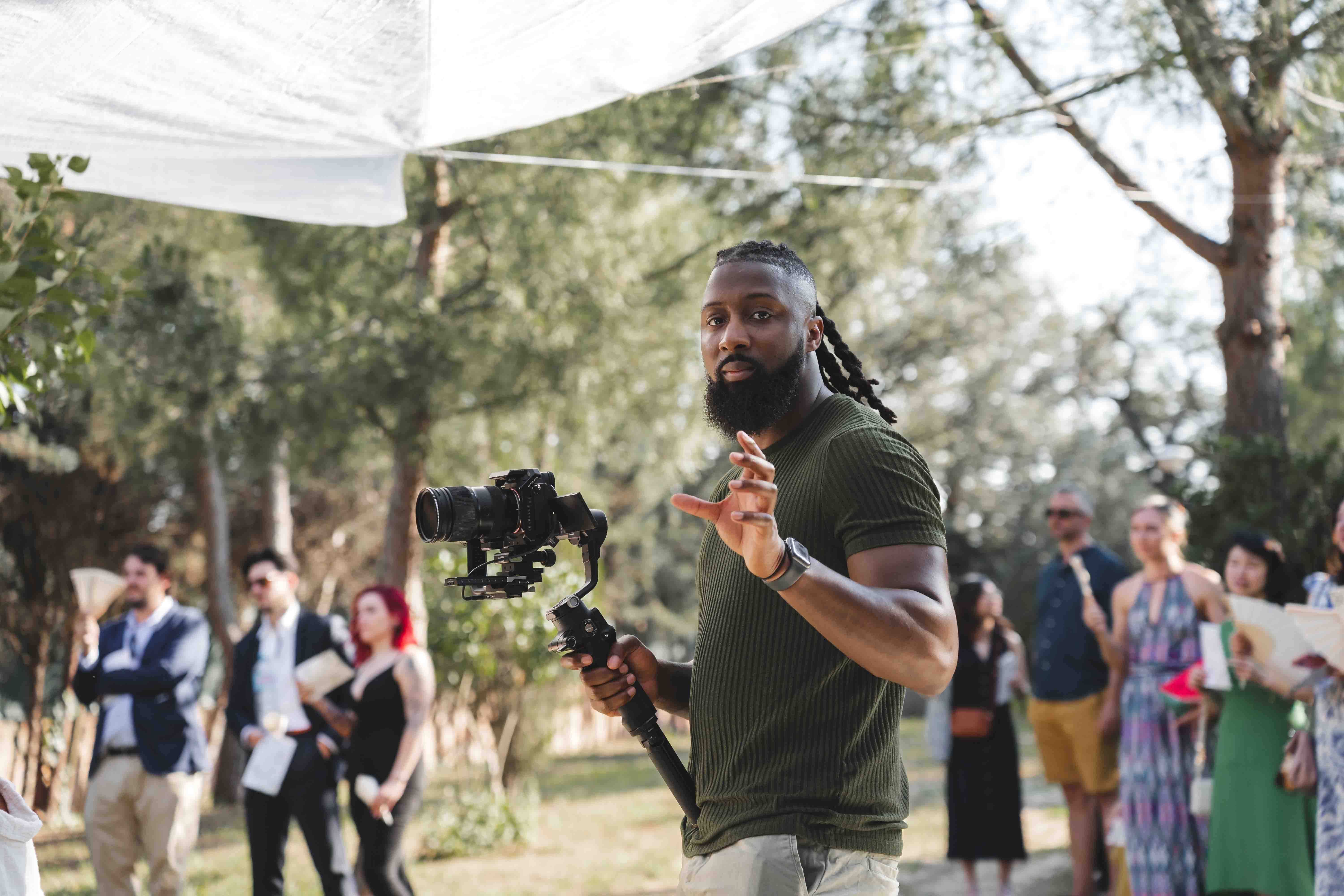 Darius Setsoafia working with a camera and handheld stabiliser